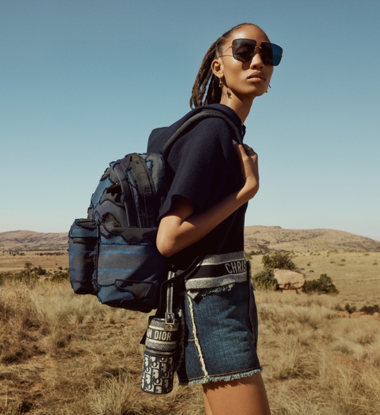 Womain hiking with a backpack and water bottle