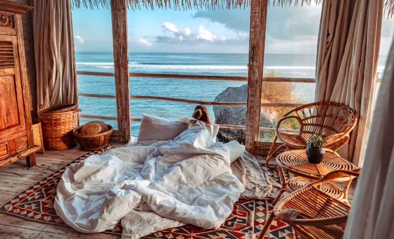 Woman in a hut looking out to sea